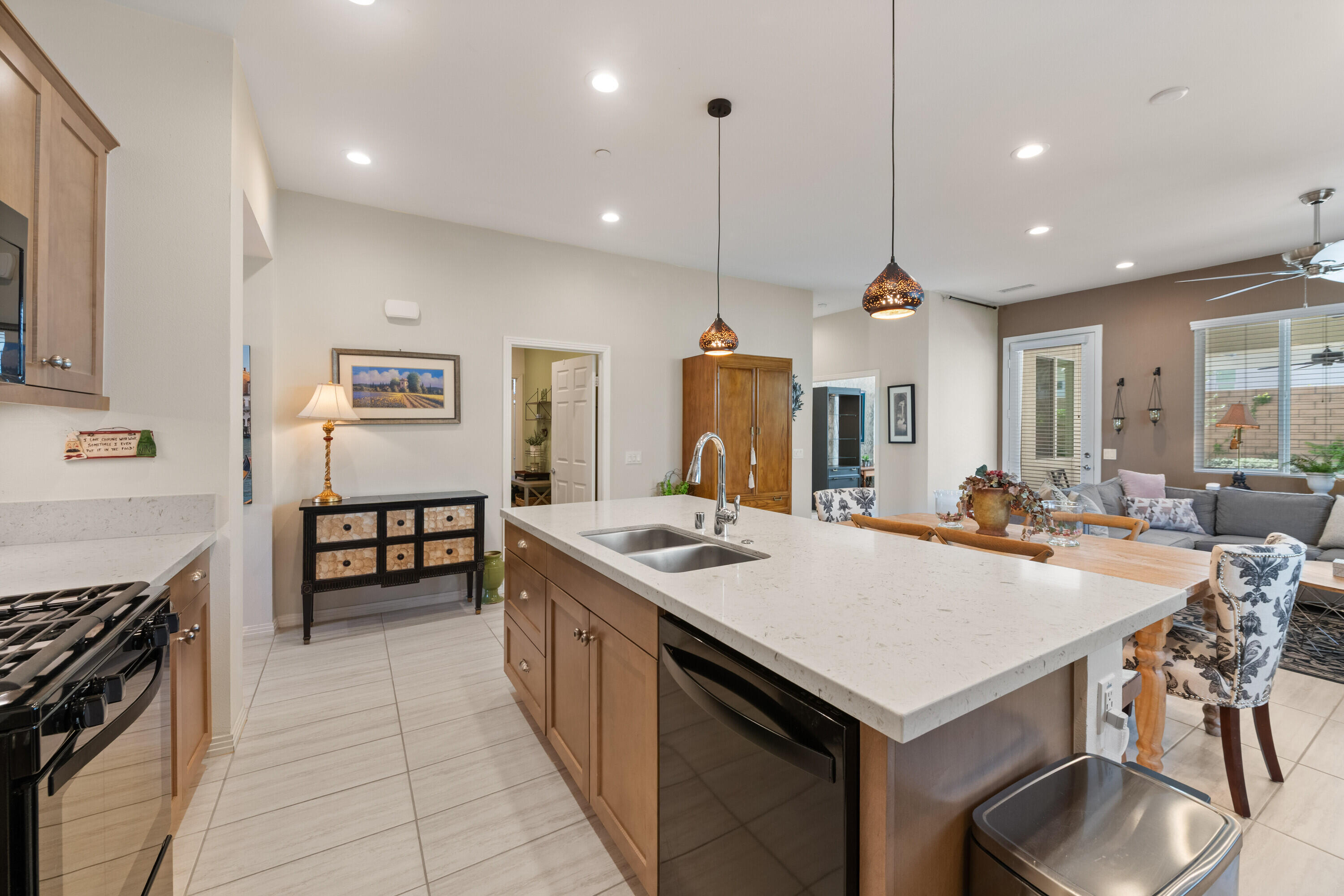 78863 Amare Way Palm Desert, CA 92211 - Photo 19 of 39 a kitchen with a stove a kitchen island a sink and chairs