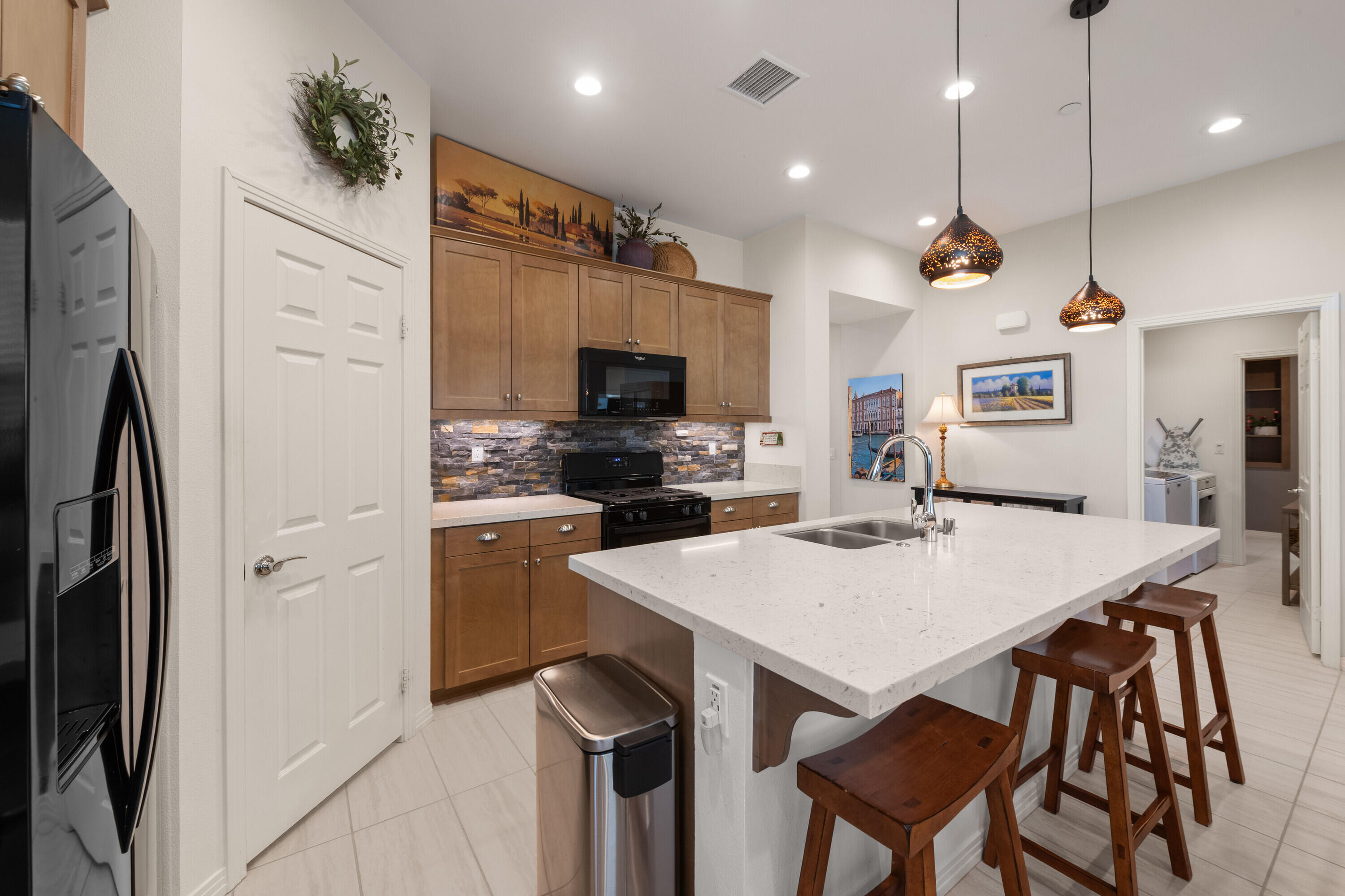 78863 Amare Way Palm Desert, CA 92211 - Photo 20 of 39 a kitchen with refrigerator cabinets and wooden floor
