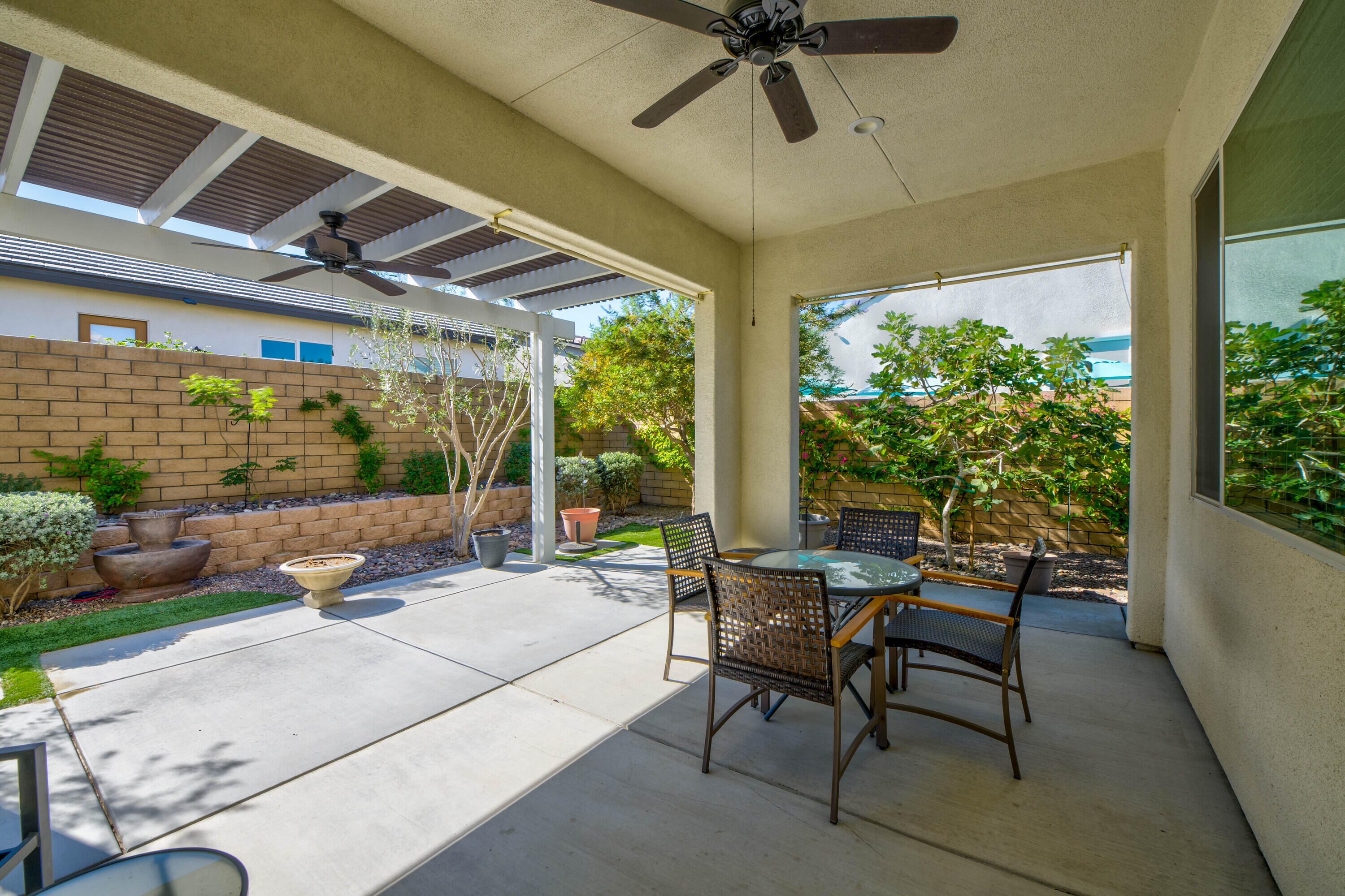 78863 Amare Way Palm Desert, CA 92211 - Photo 32 of 39 a outdoor space with patio the couches and a dining table with garden view
