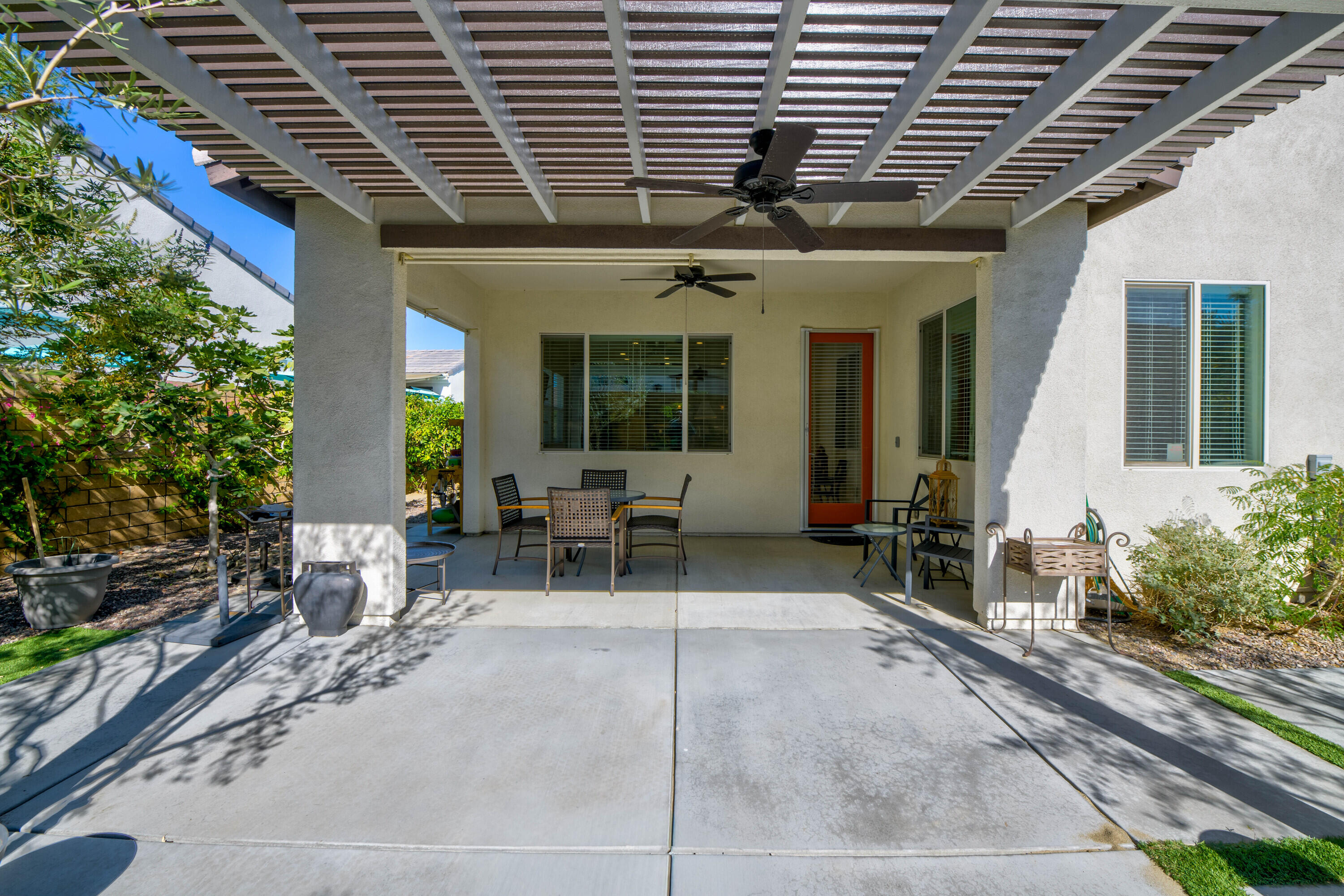 78863 Amare Way Palm Desert, CA 92211 - Photo 37 of 39 a view of a patio with table and chairs and potted plants