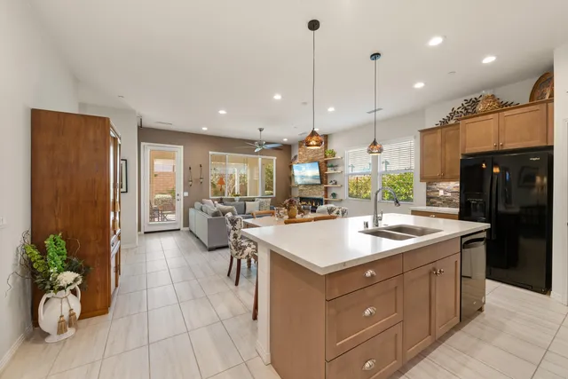 a kitchen with kitchen island a stove a table and chairs in it