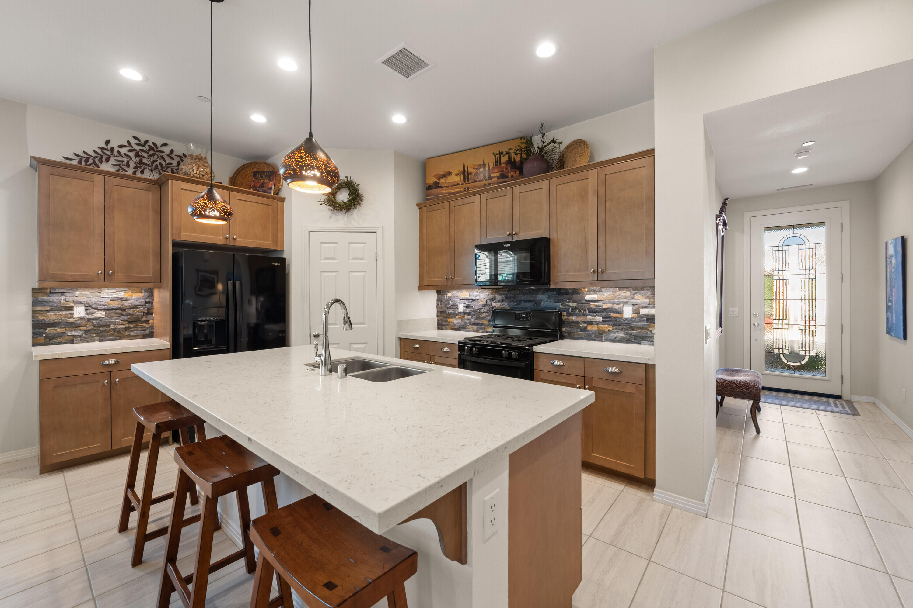 78863 Amare Way Palm Desert, CA 92211 - Photo 5 of 39 a kitchen with kitchen island a stove a table and chairs in it