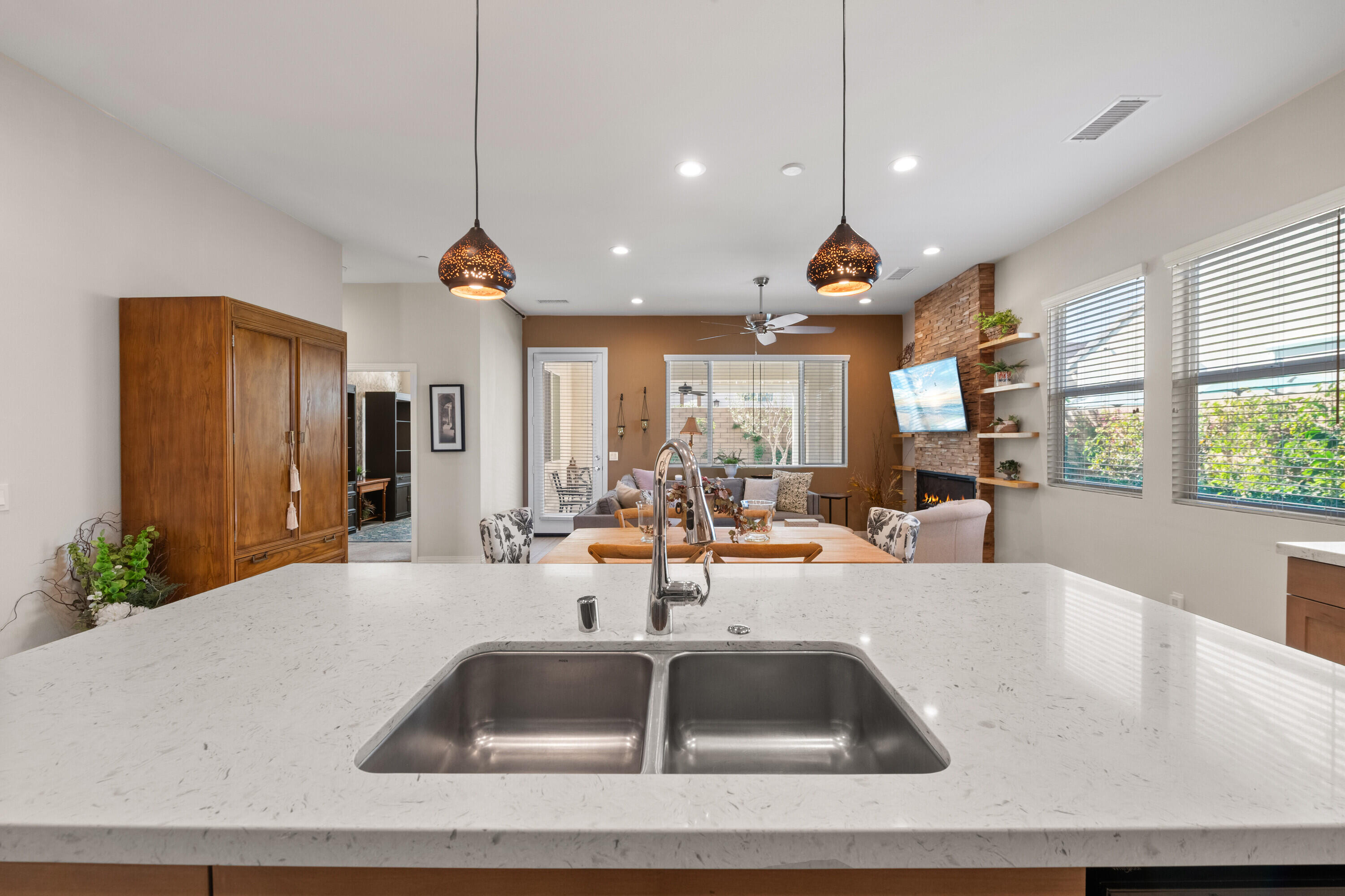78863 Amare Way Palm Desert, CA 92211 - Photo 8 of 39 a kitchen with a sink a counter top space and living room view