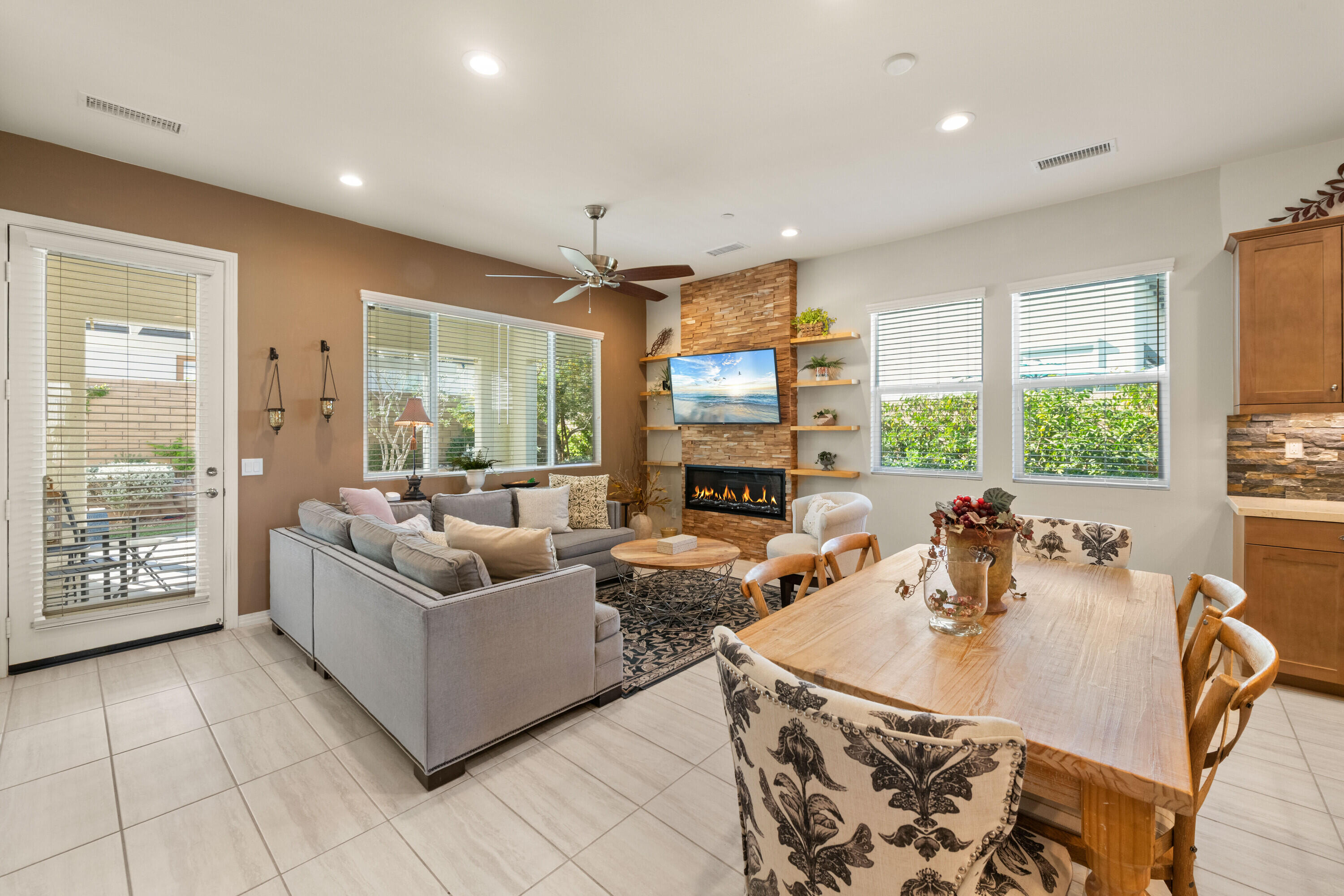 78863 Amare Way Palm Desert, CA 92211 - Photo 9 of 39 a living room with fireplace furniture and a large window