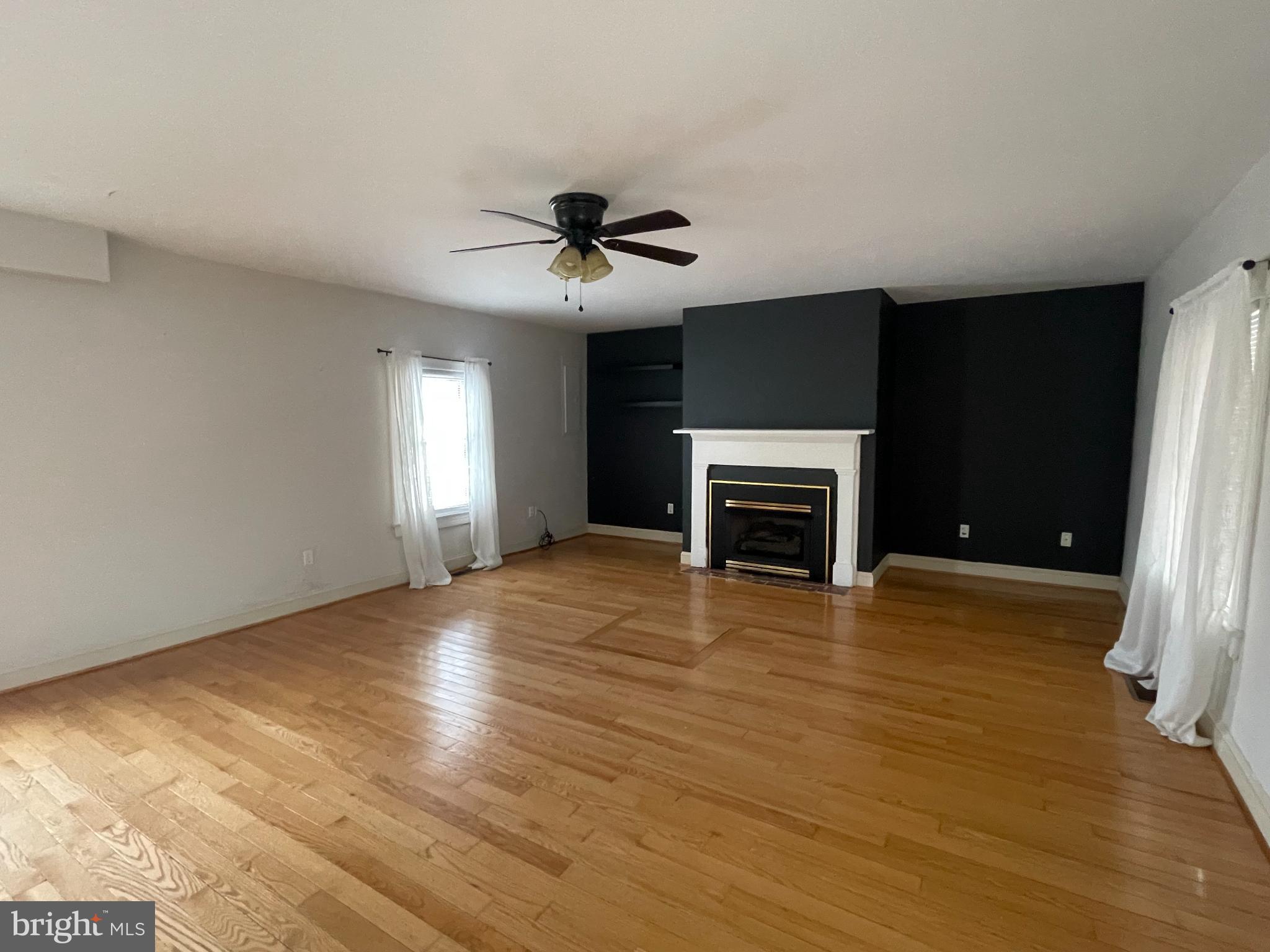 33 Crookhorn Road Montross, VA 22520 - Photo 4 of 18 a view of empty room with wooden floor and fireplace