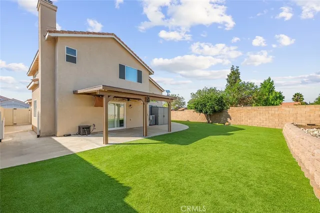 a view of a house with a yard and sitting area