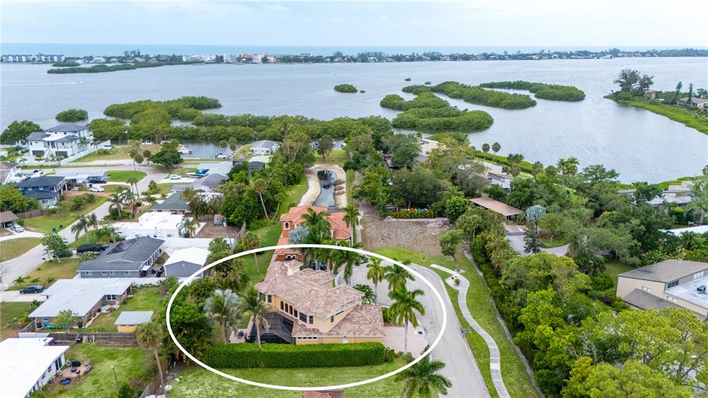 1630 Assisi Drive, Unit 18 Sarasota, FL 34231 - Photo 35 of 42 a view of a lake from a balcony with outdoor seating