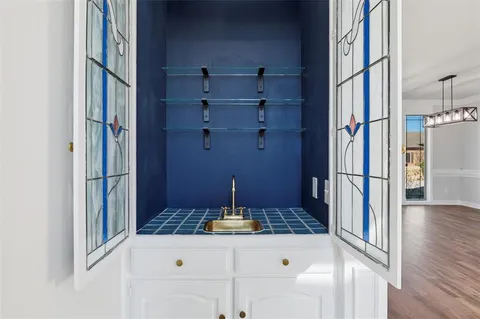 a kitchen with white cabinets stainless steel appliances and sink