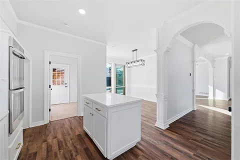 a view of a kitchen with white cabinets