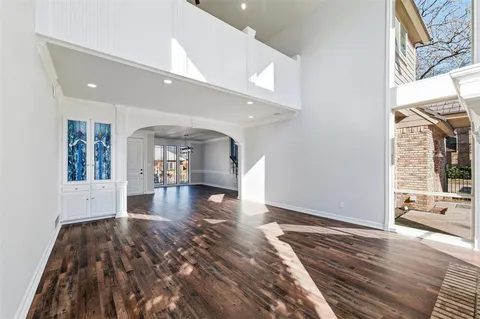 a kitchen with a sink a refrigerator and cabinets