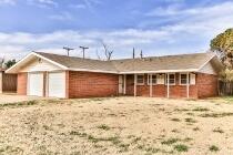 5408 31st Street Lubbock, TX 79407 - Photo 2 of 33 a front view of a house with a yard