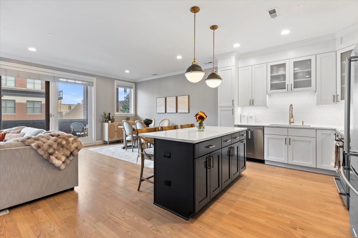 2463 West Foster Avenue, Unit 3 Chicago, IL 60625 - Photo 14 of 31 a kitchen with stainless steel appliances granite countertop a sink and a wooden floors