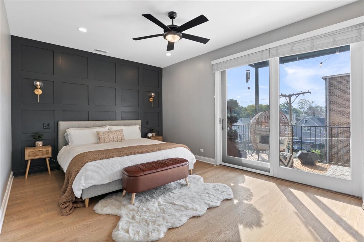 2463 West Foster Avenue, Unit 3 Chicago, IL 60625 - Photo 15 of 31 a bedroom with a large bed and a chandelier fan