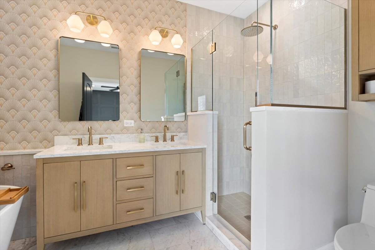 2463 West Foster Avenue, Unit 3 Chicago, IL 60625 - Photo 18 of 31 a bathroom with a double vanity sink mirror and shower
