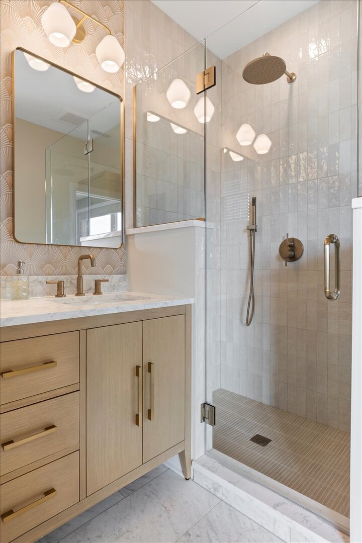 2463 West Foster Avenue, Unit 3 Chicago, IL 60625 - Photo 20 of 31 a bathroom with a shower sink and mirror