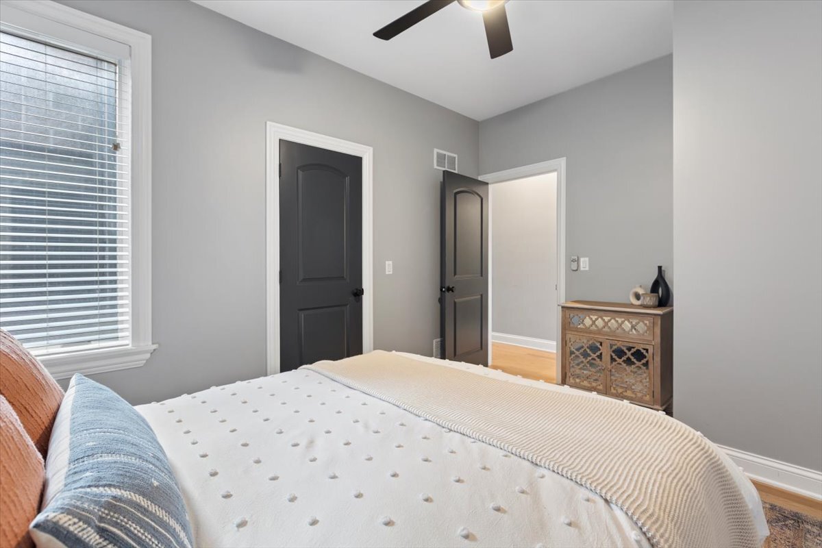 2463 West Foster Avenue, Unit 3 Chicago, IL 60625 - Photo 22 of 31 a bedroom with a bed and a chandelier