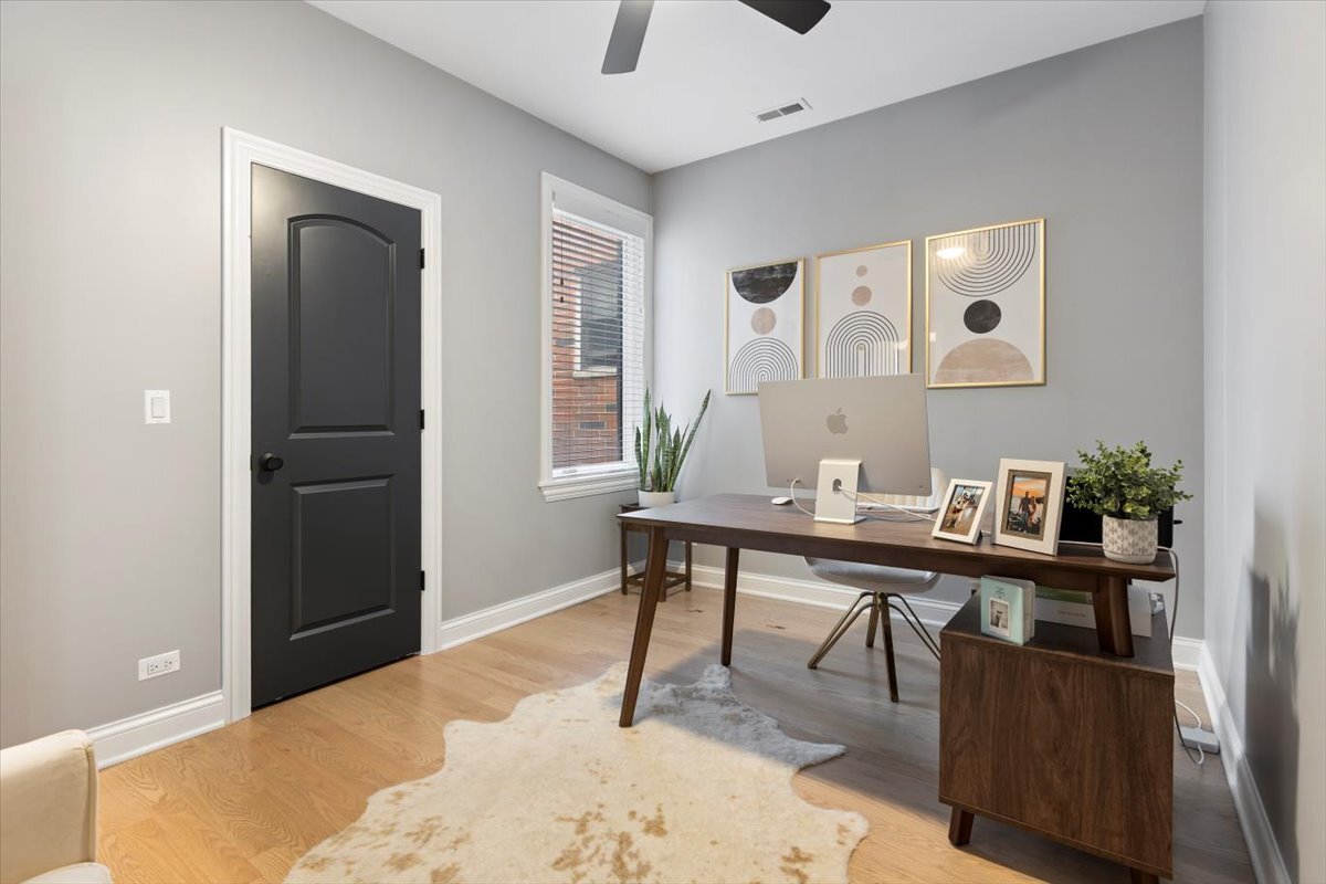 2463 West Foster Avenue, Unit 3 Chicago, IL 60625 - Photo 24 of 31 a view of a workspace room with wooden floor and windows