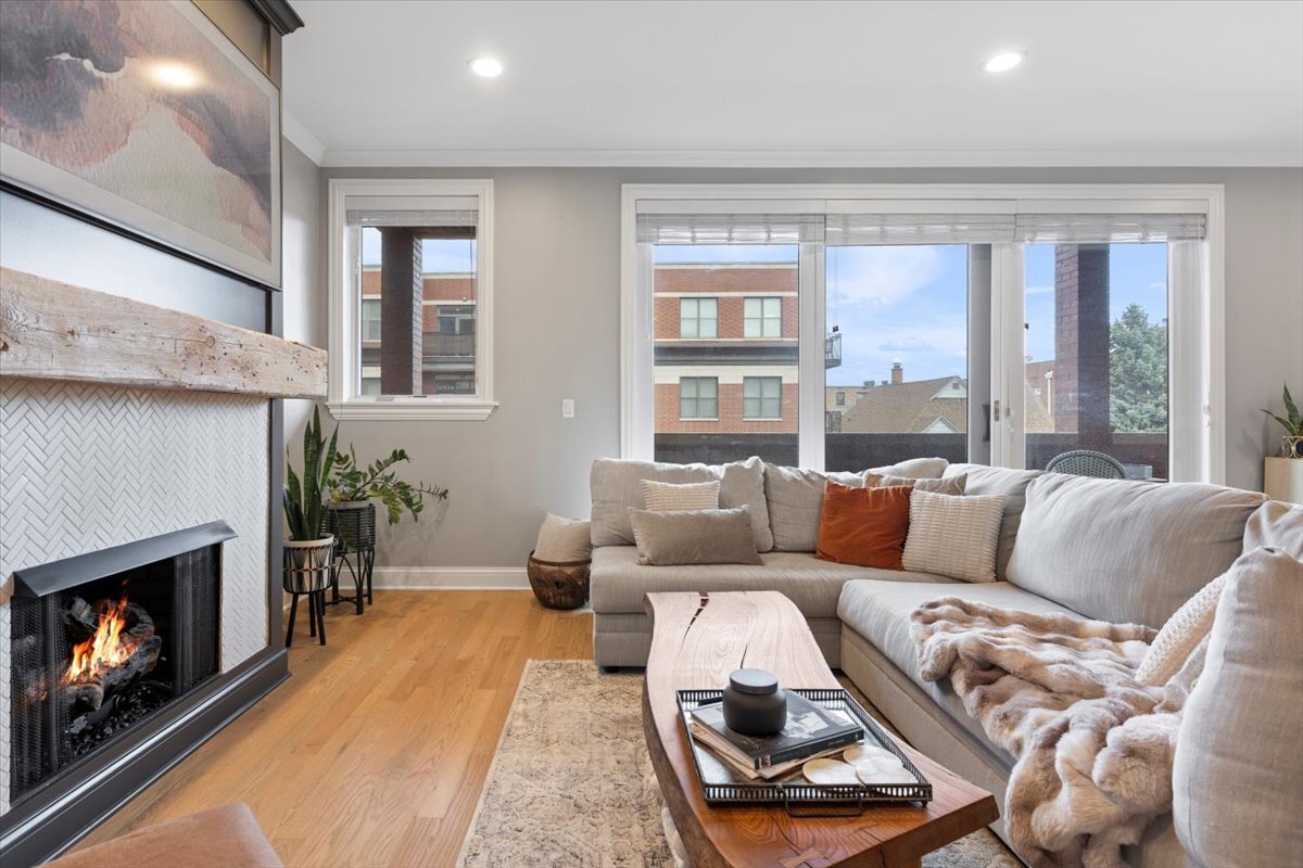 2463 West Foster Avenue, Unit 3 Chicago, IL 60625 - Photo 4 of 31 a living room with furniture and a fireplace