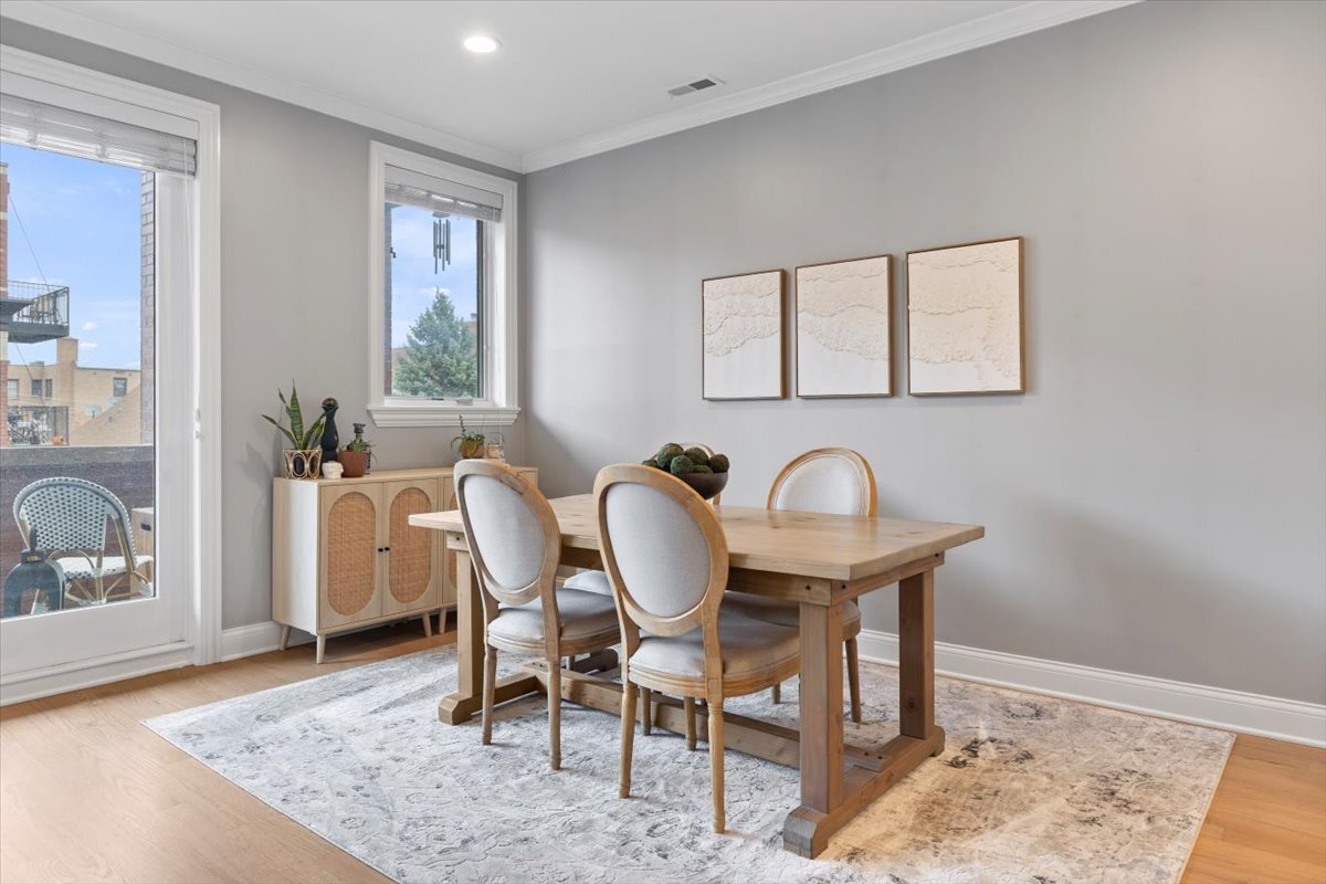 2463 West Foster Avenue, Unit 3 Chicago, IL 60625 - Photo 7 of 31 a view of a dining room with furniture and window