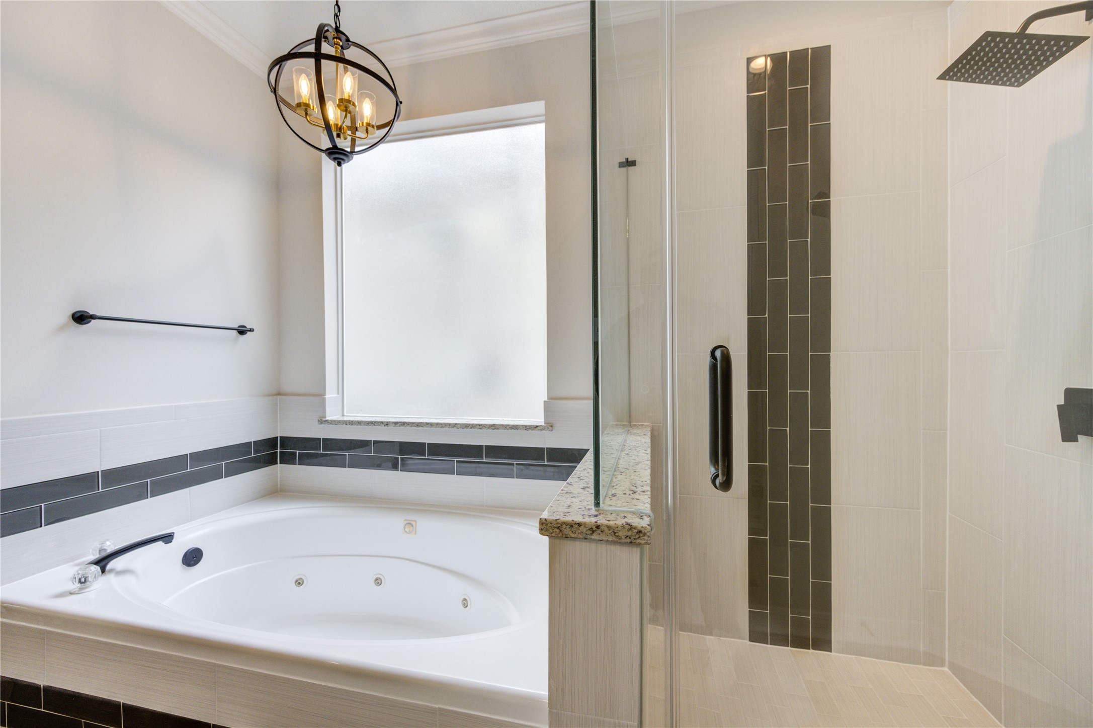 17318 Bonnard Circle Spring, TX 77379 - Photo 28 of 45 The jetted tub and shower are separate. The tub has been updated with surround vertical-set tile. The shower has gray glass accent inserts and a new frameless enclosure. It is stunning!