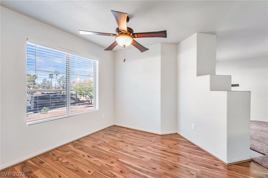 698 South Racetrack Road, Unit 1512 Henderson, NV 89015 - Photo 13 of 30 Rich wood-look flooring and clean white walls define this versatile interior space.