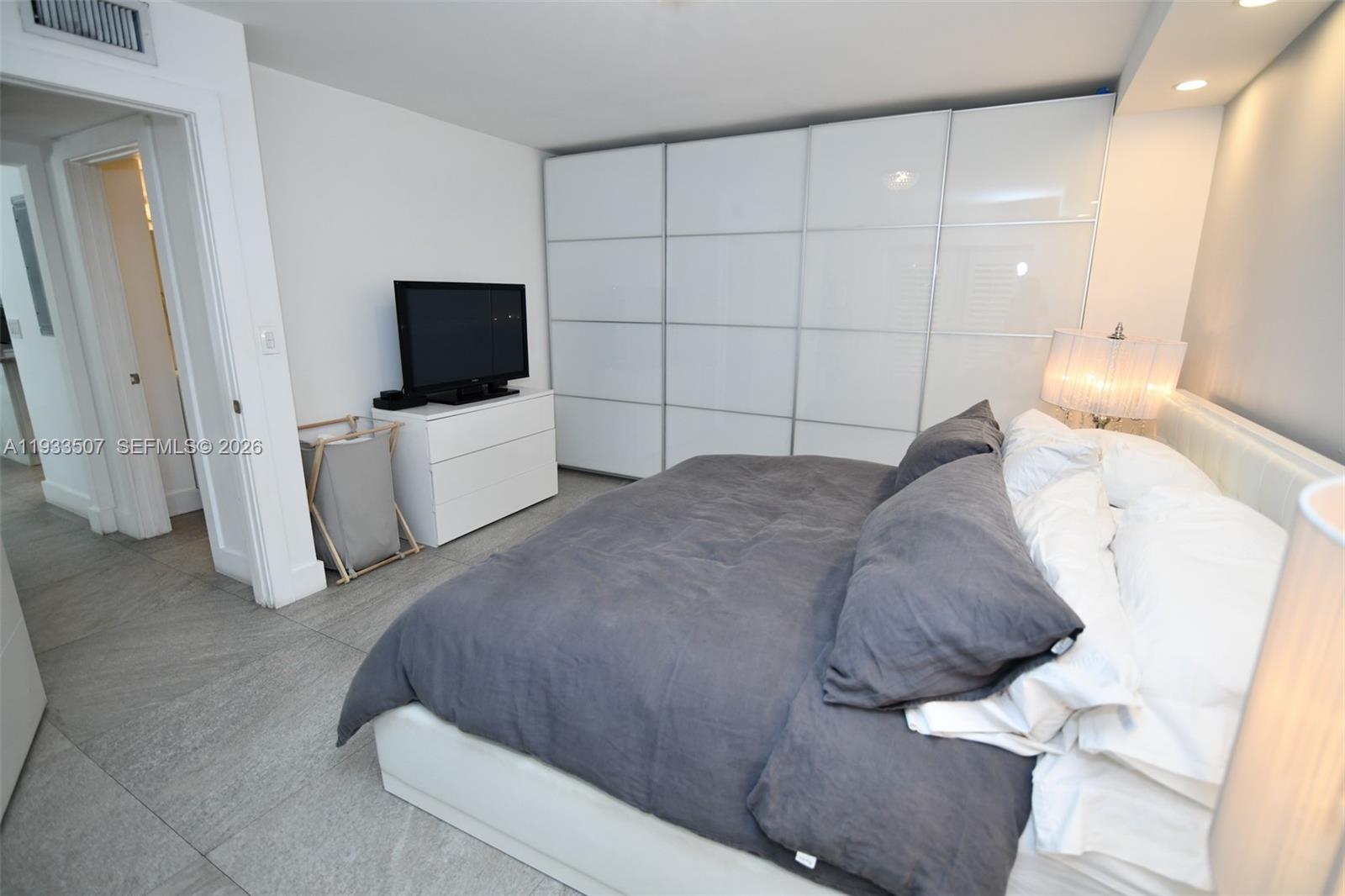 2918 Bird Avenue, Unit 5 Miami, FL 33133 - Photo 19 of 29 a bedroom with a bed and a flat screen tv