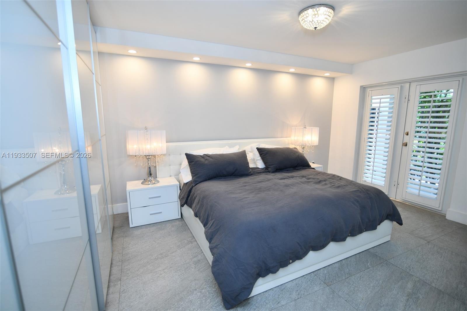 2918 Bird Avenue, Unit 5 Miami, FL 33133 - Photo 20 of 29 a bedroom with a bed and window