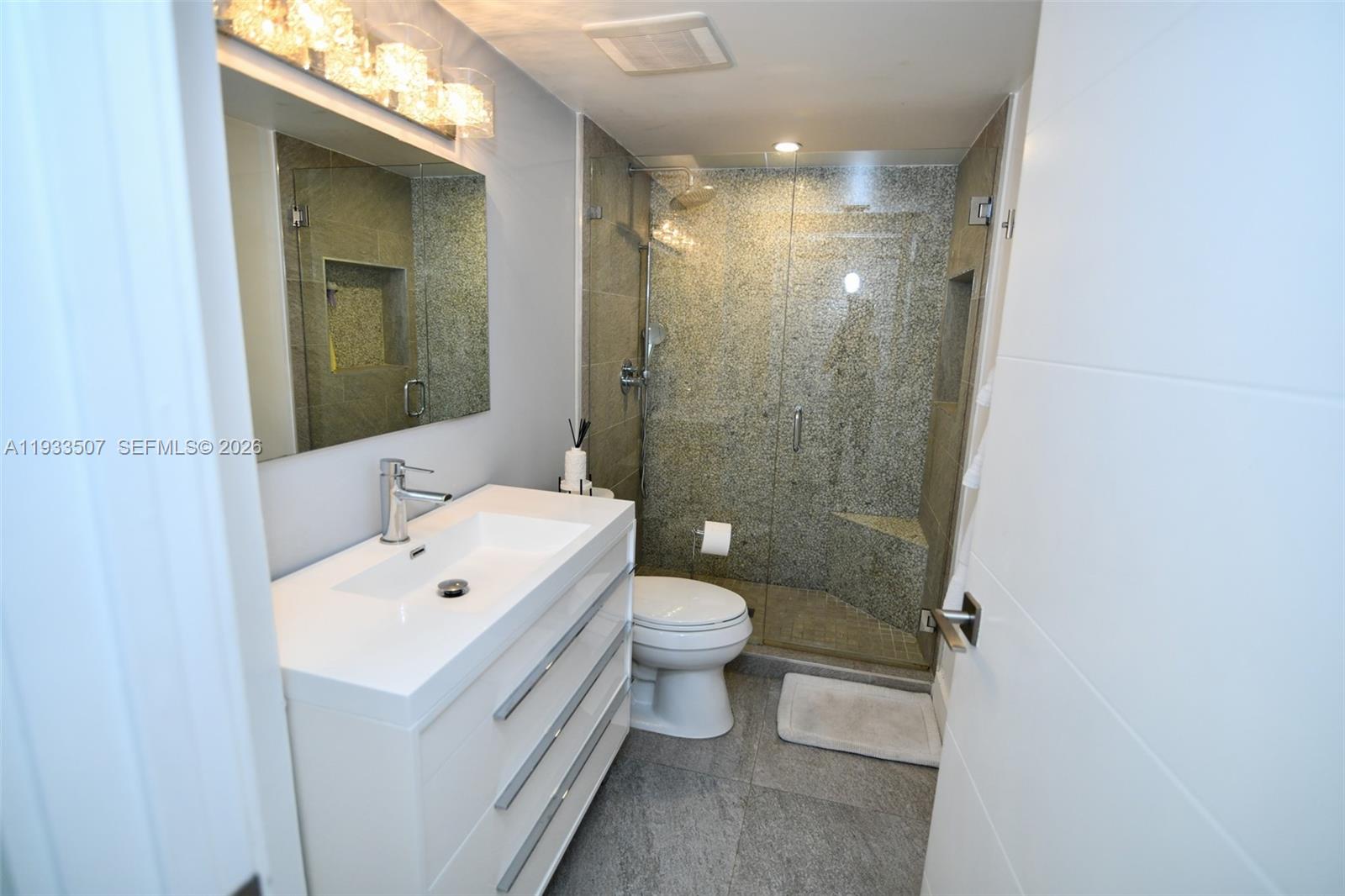 2918 Bird Avenue, Unit 5 Miami, FL 33133 - Photo 21 of 29 a bathroom with a sink a toilet and shower