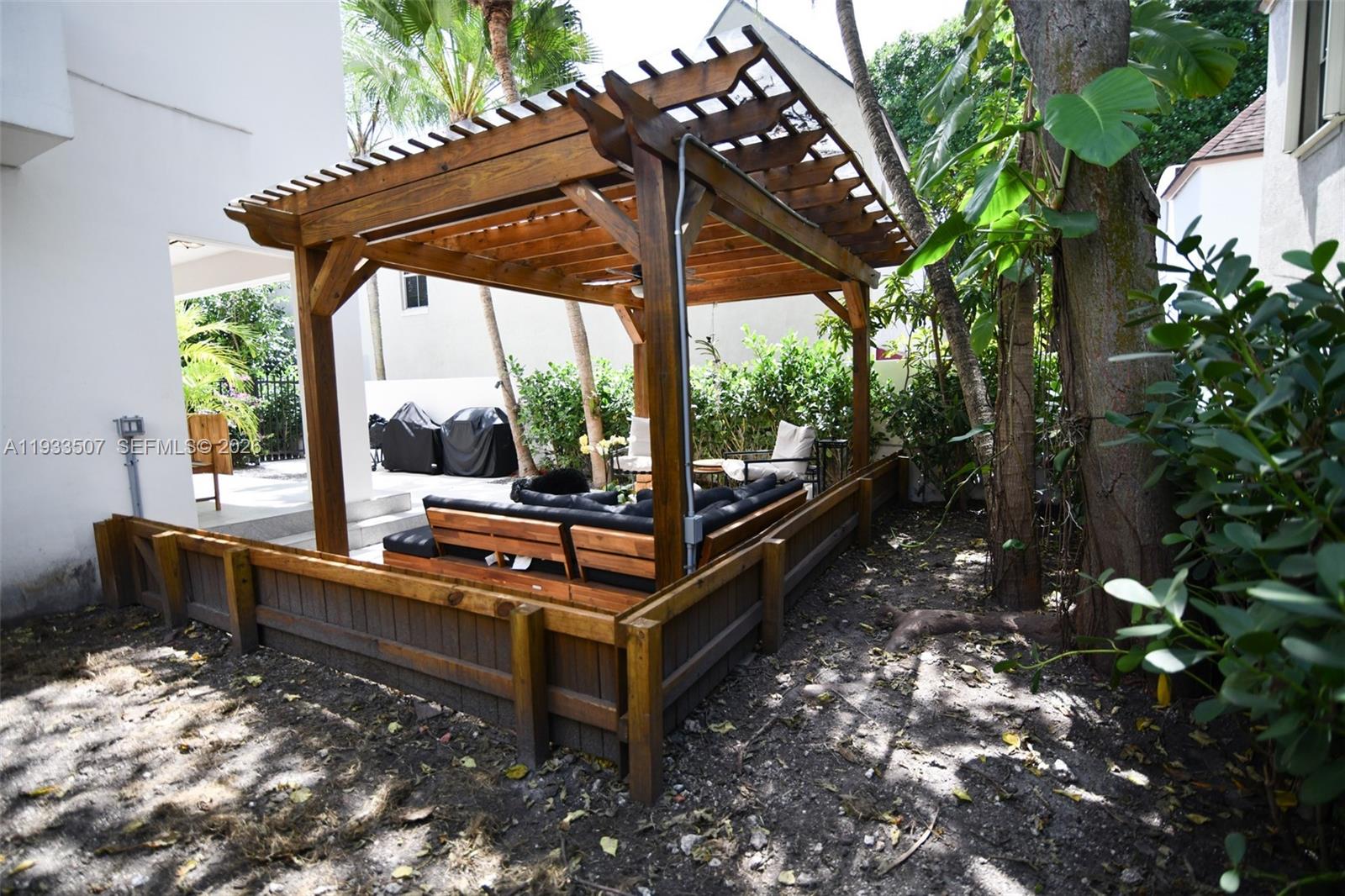 2918 Bird Avenue, Unit 5 Miami, FL 33133 - Photo 27 of 29 a view of a bench in a patio