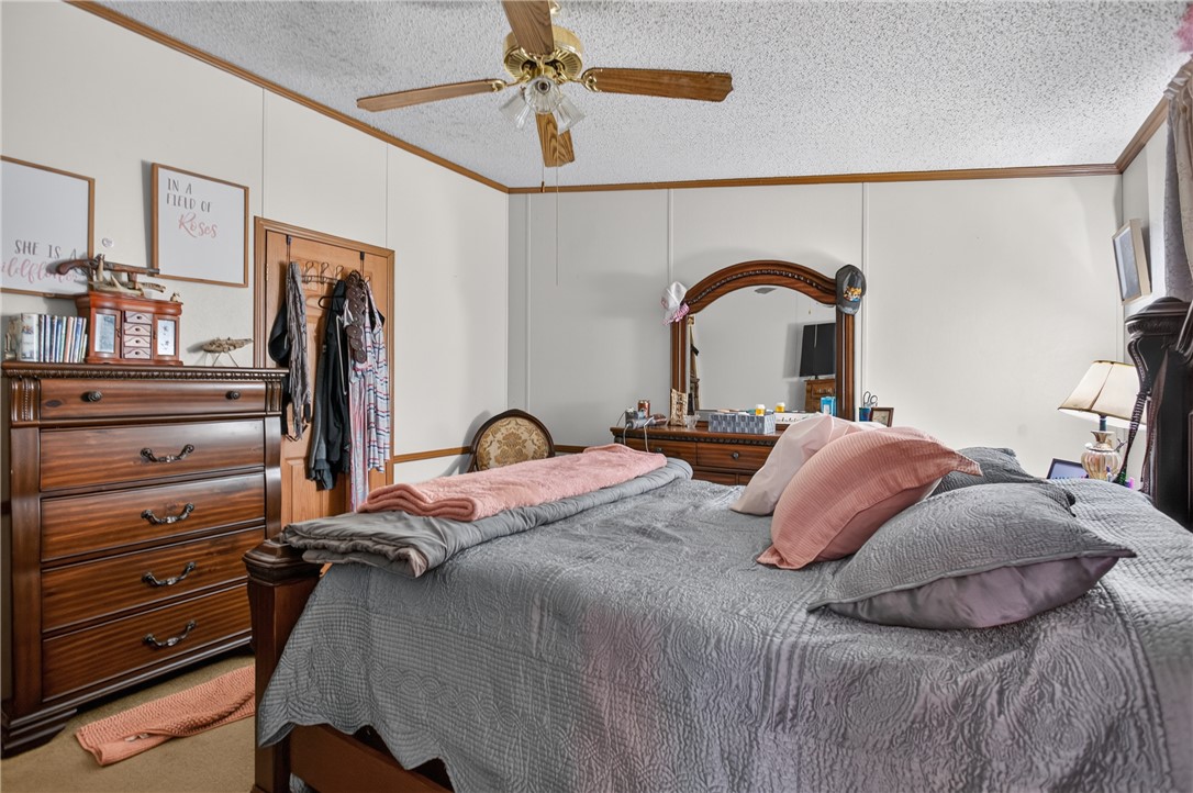 418 Chauga Road Westminster, SC 29693 - Photo 12 of 38 Comfortable living quarters featuring a ceiling fan, offering a tranquil retreat.