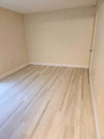 a view of an empty room and wooden floor