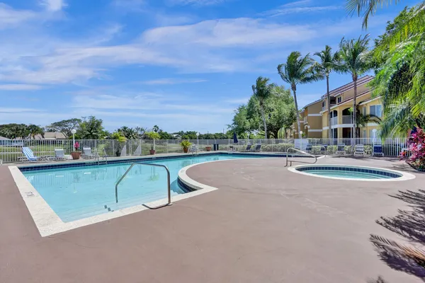 a view of a house with swimming pool and sitting area