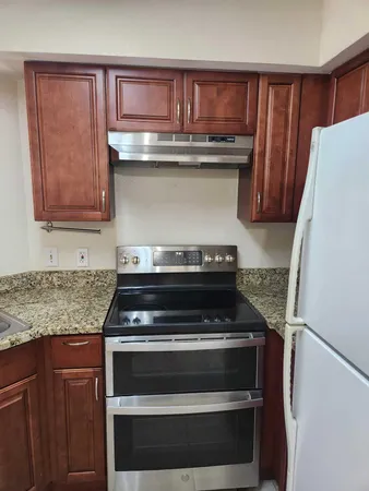 a kitchen with a refrigerator and a stove