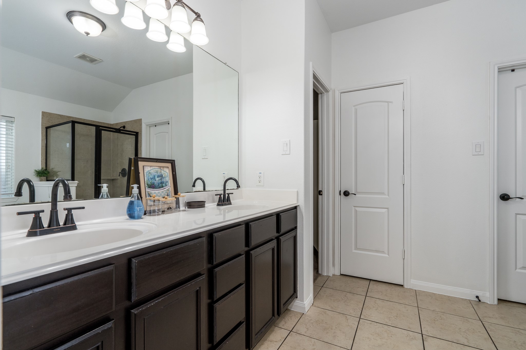 18879 Atascosa Trail Magnolia, TX 77355 - Photo 12 of 25 a bathroom with a double vanity sink and a mirror
