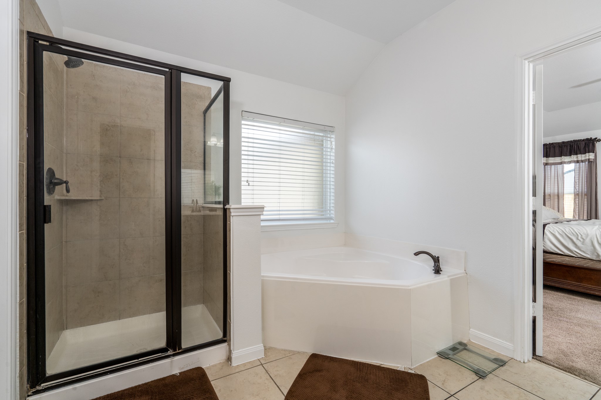 18879 Atascosa Trail Magnolia, TX 77355 - Photo 13 of 25 a bathroom with a bathtub and a shower
