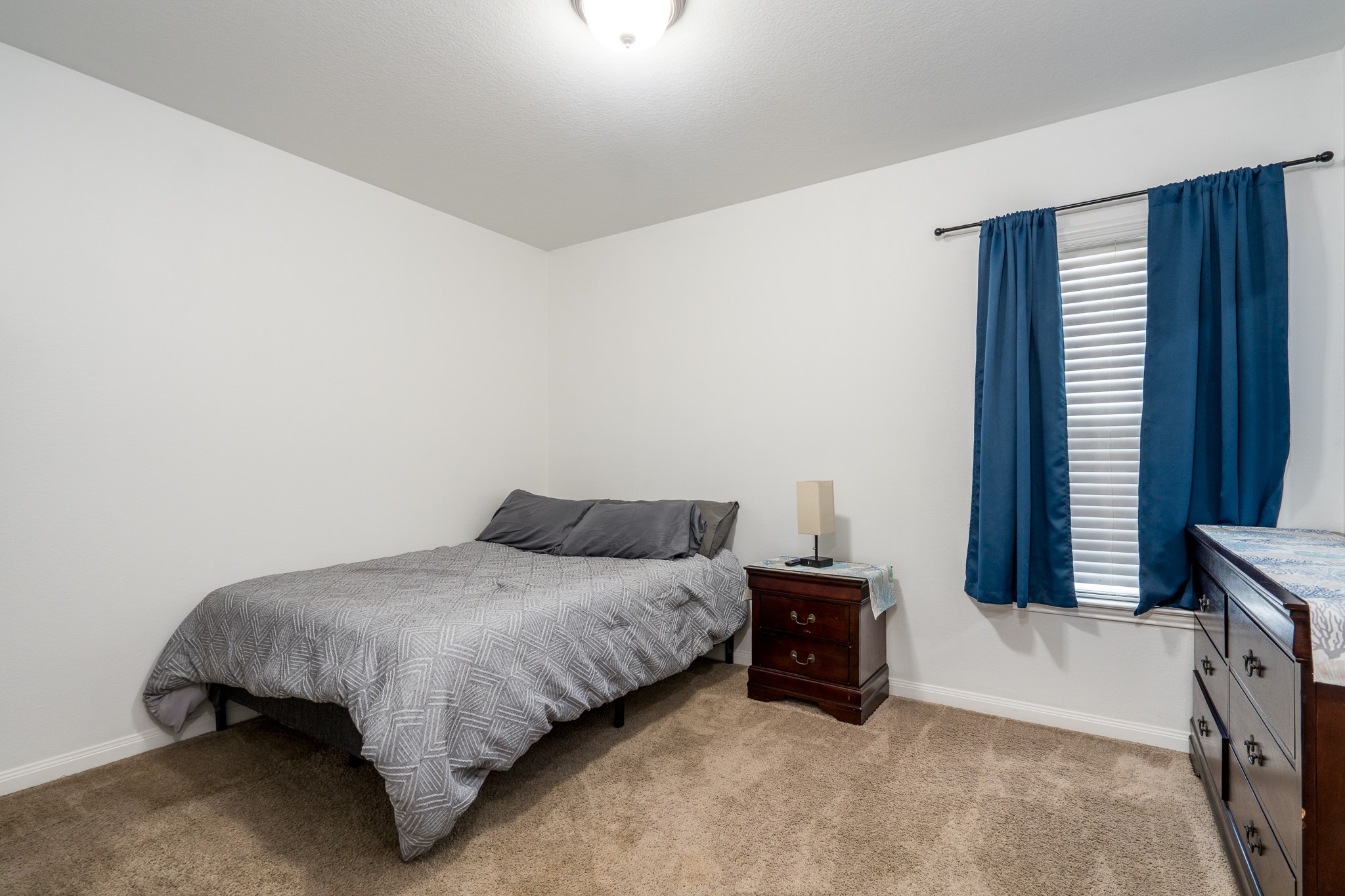 18879 Atascosa Trail Magnolia, TX 77355 - Photo 14 of 25 a bedroom with a bed and a window