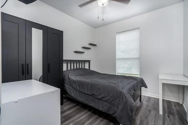 a bedroom with a bed and a chandelier