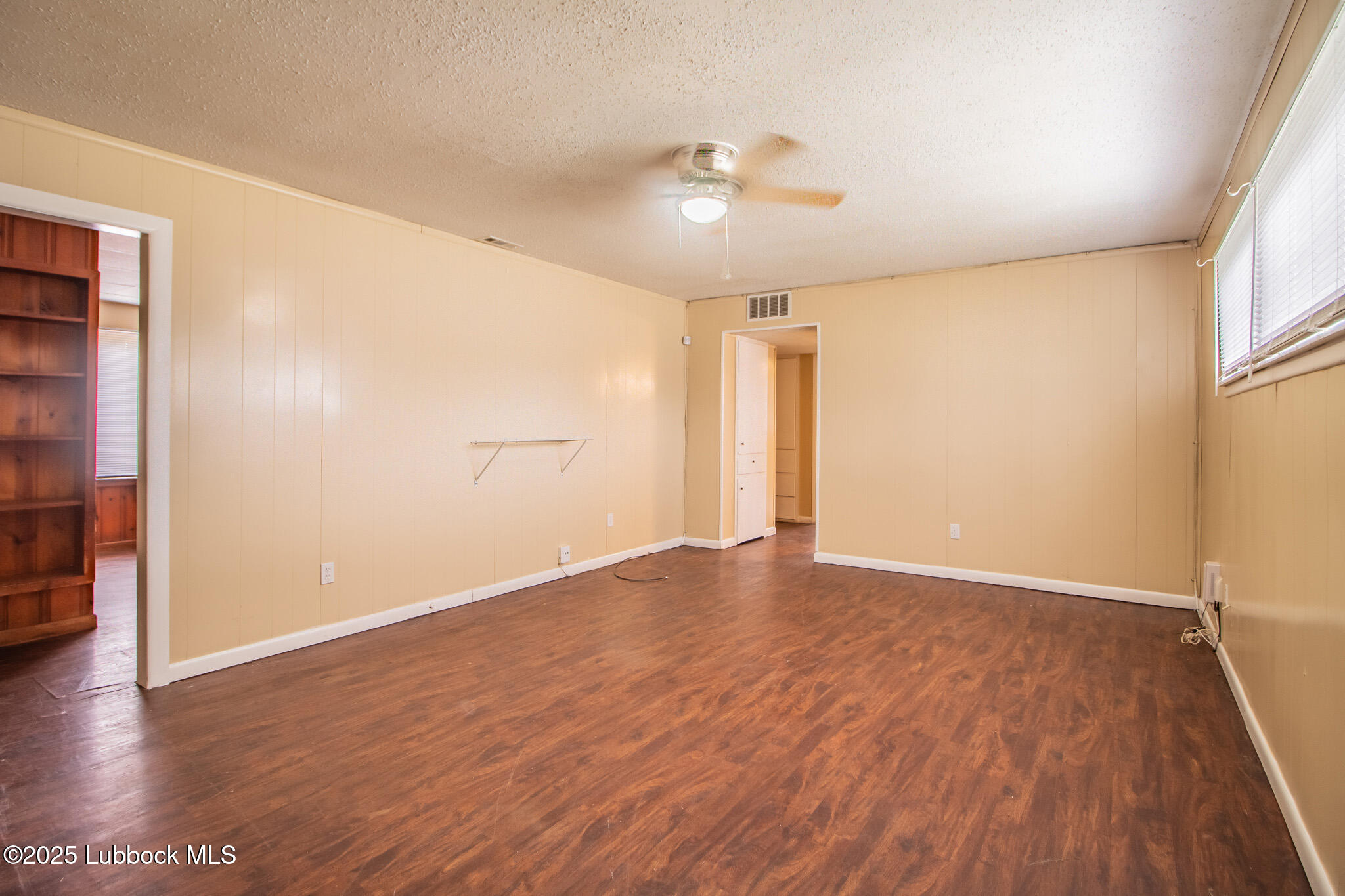 2414 38th Street Lubbock, TX 79412 - Photo 5 of 20 wooden floor in an empty room with a window