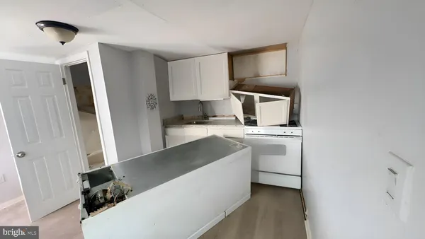 a view of a small space with wooden floor and a window