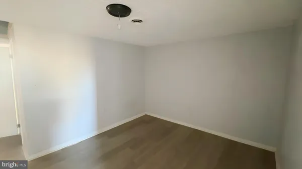 a view of a hallway with wooden floor and entryway