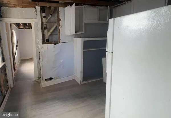 a utility room with wooden floor washer and dryer