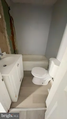 a view of a room with wooden floor and windows