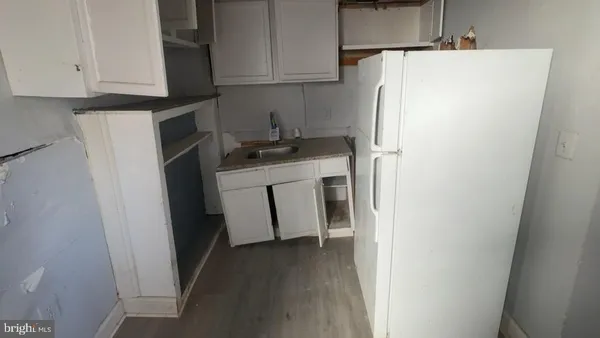 a room with water heater and wooden cabinets