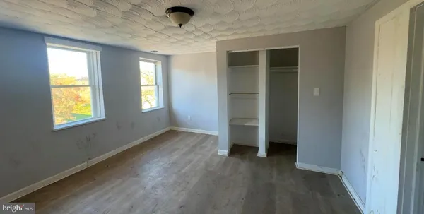 an empty room with a empty space and windows