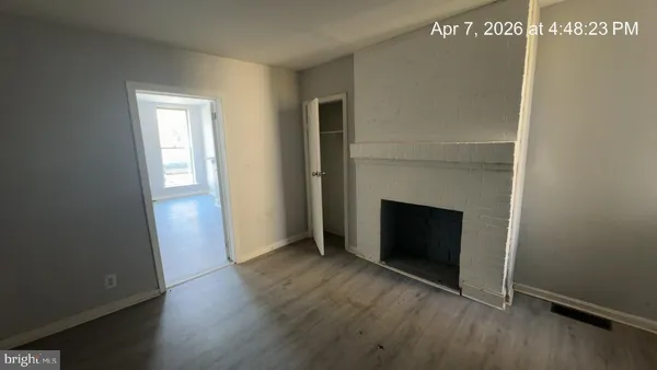a view of a room with wooden floor and windows