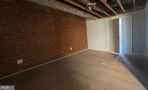 a view of a room with an empty space and a window