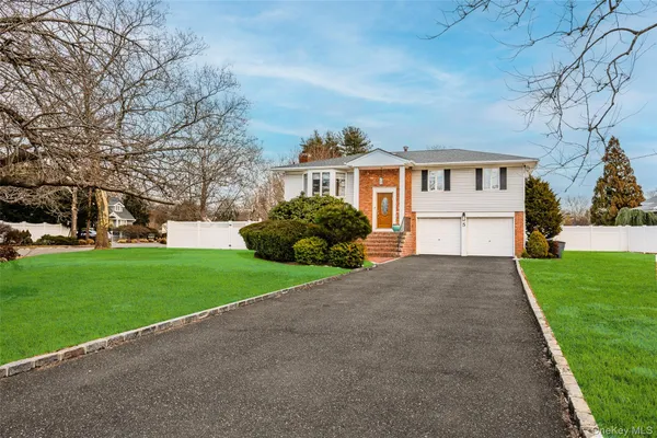 a front view of house with yard and green space