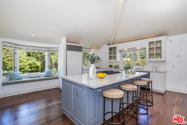 a bedroom with a large bed and a large window