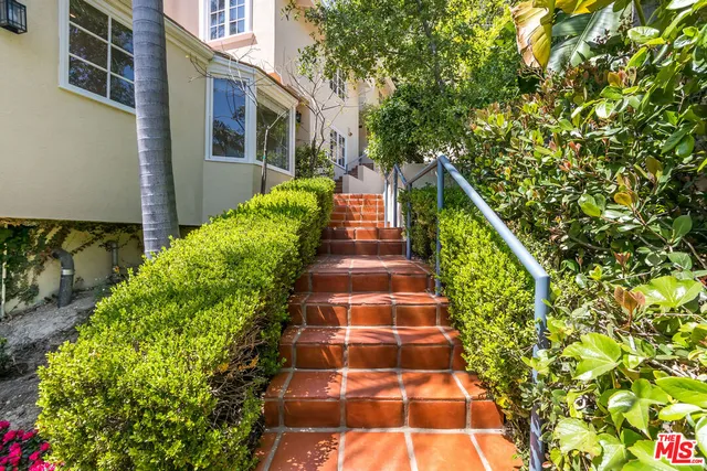 a view of a backyard with table and chairs wooden floor and fence