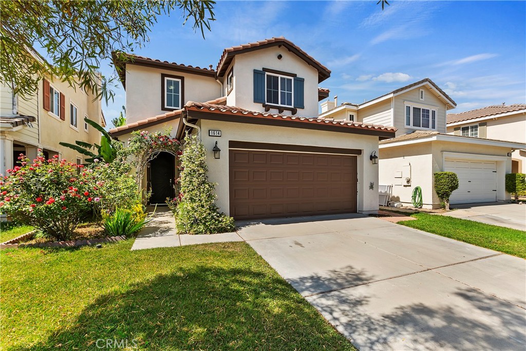 1614 Rigel Street Beaumont, CA 92223 - Photo 1 of 1 a front view of a house with a yard and garage